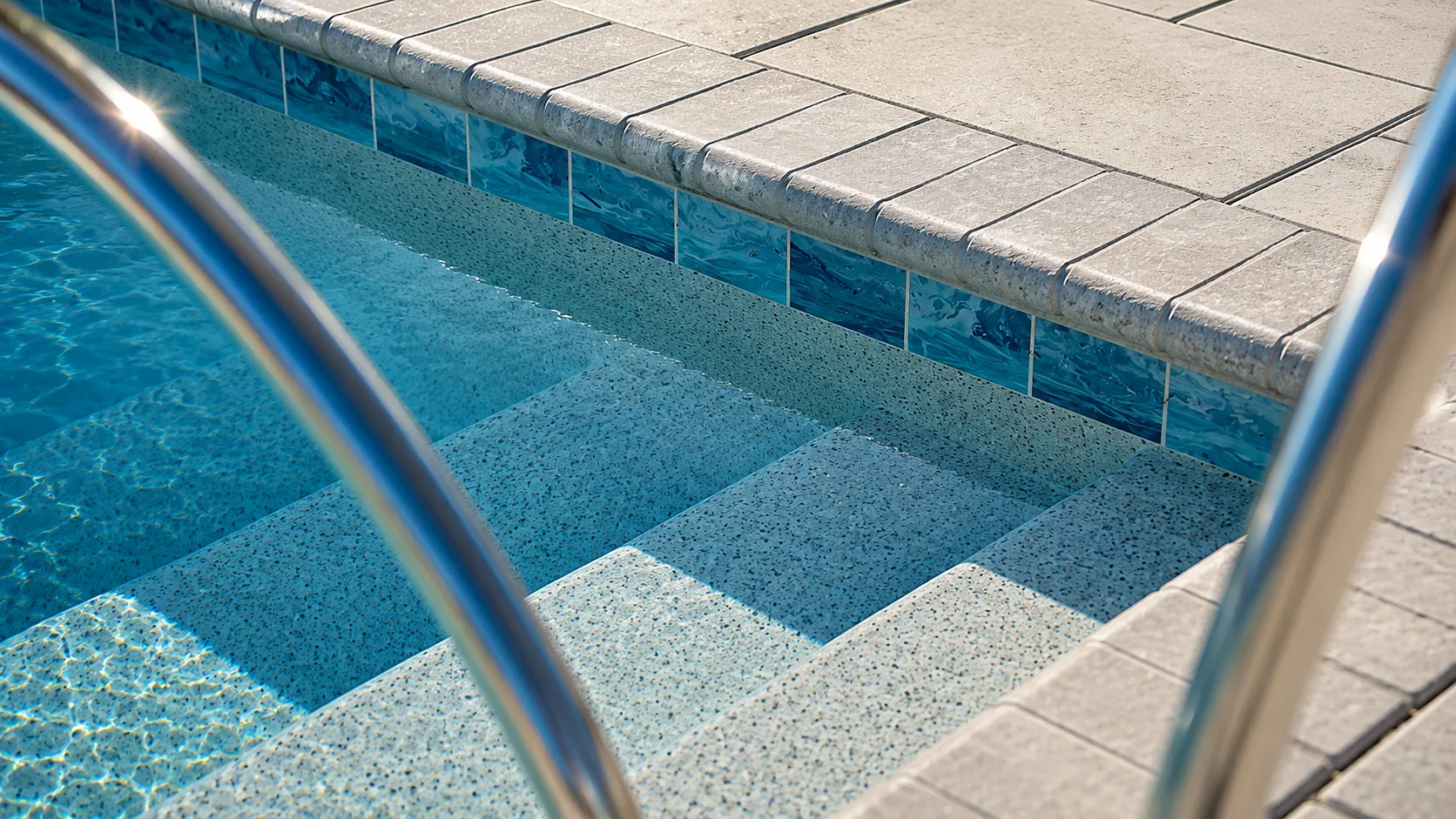 Pool entry steps and tanning ledge on a Neway Pools project