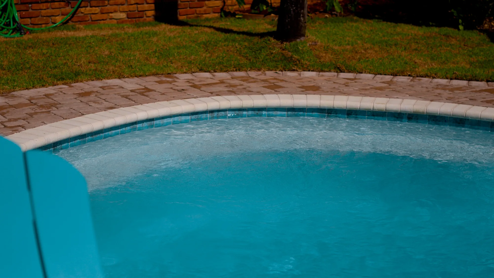 Poolside living space beside a custom Neway Pools pool