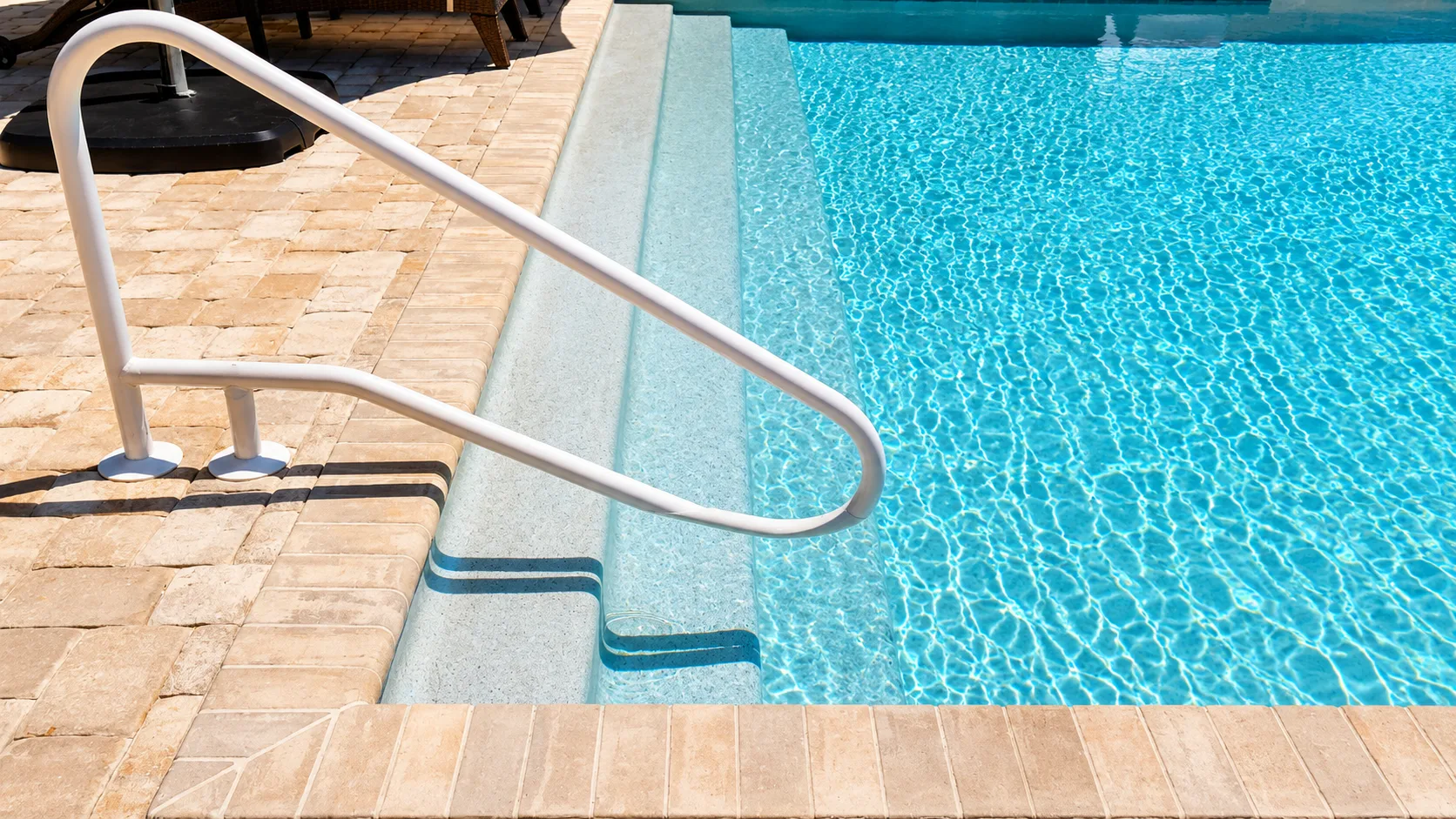 Pool coping and paver decking on a custom Neway pool