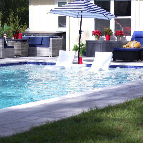 pool, loungers, umbrella by Walton County pool Builder neway pools in FL
