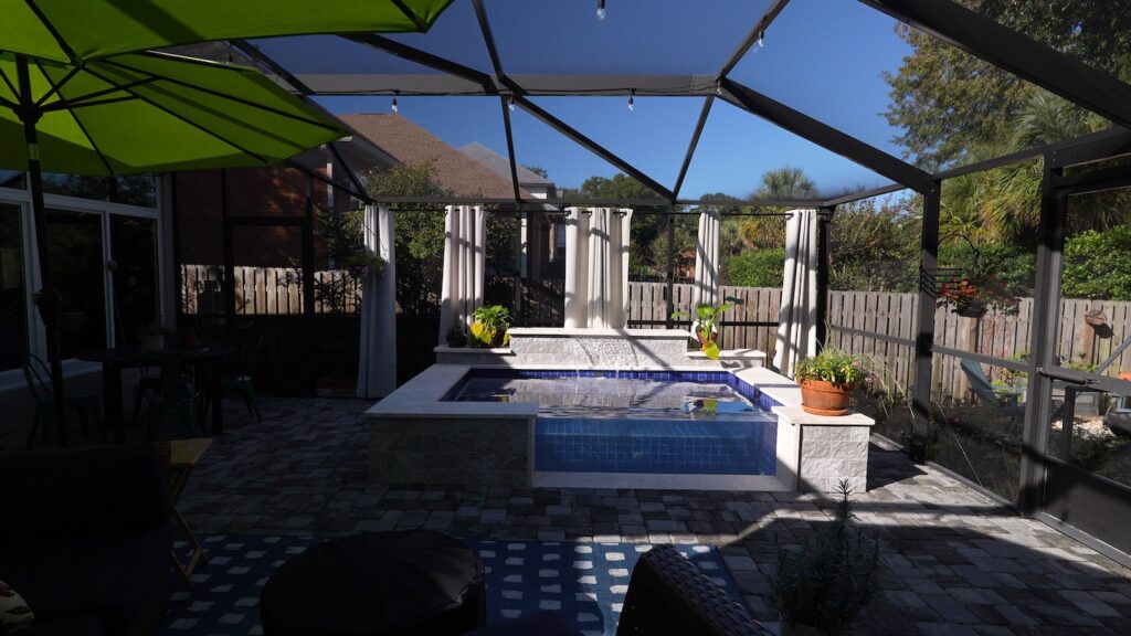 pool in backyard with pool cage, by walton county pool builder neway pools in florida