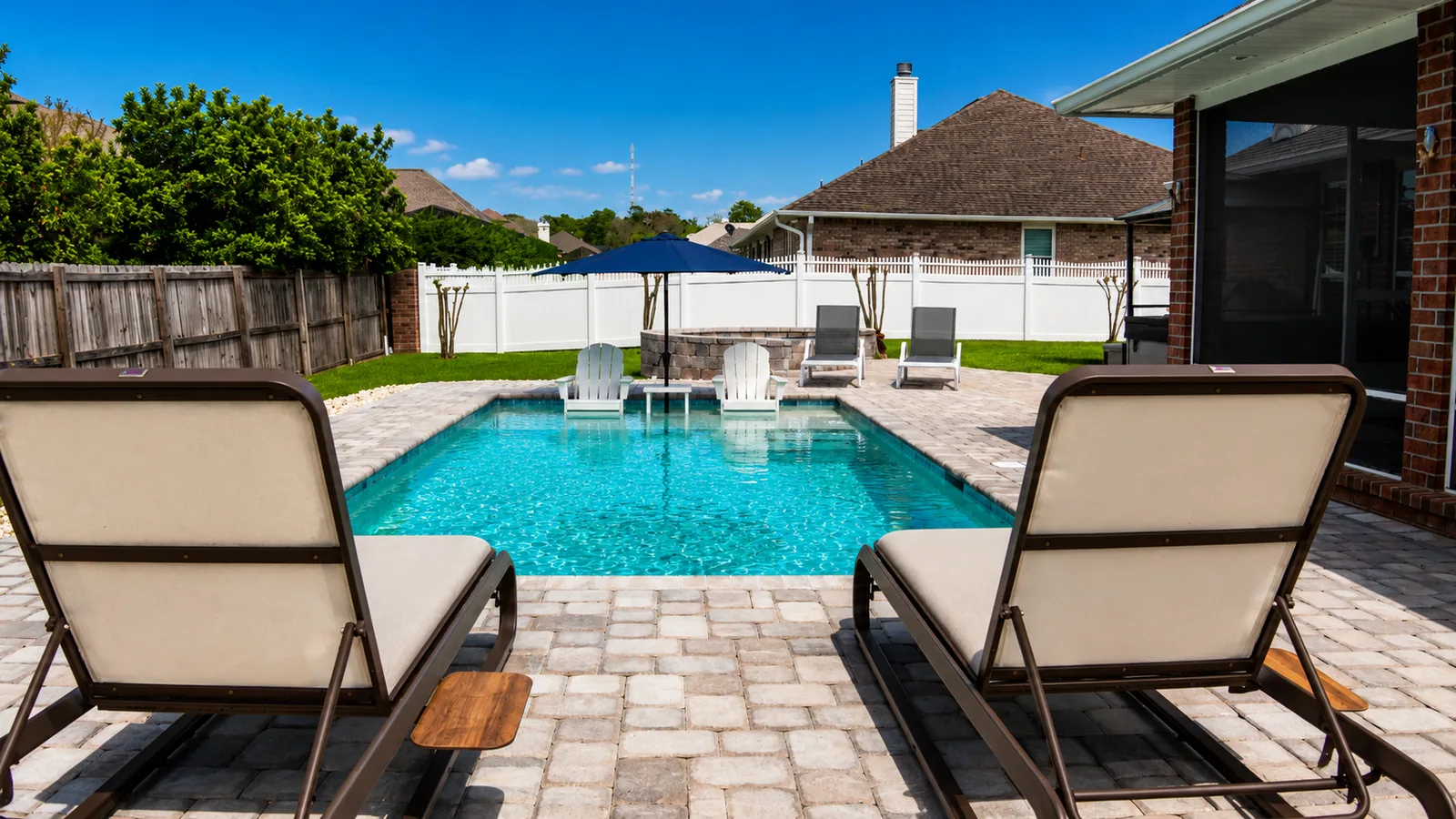 Poolside lounge area beside a custom Neway pool
