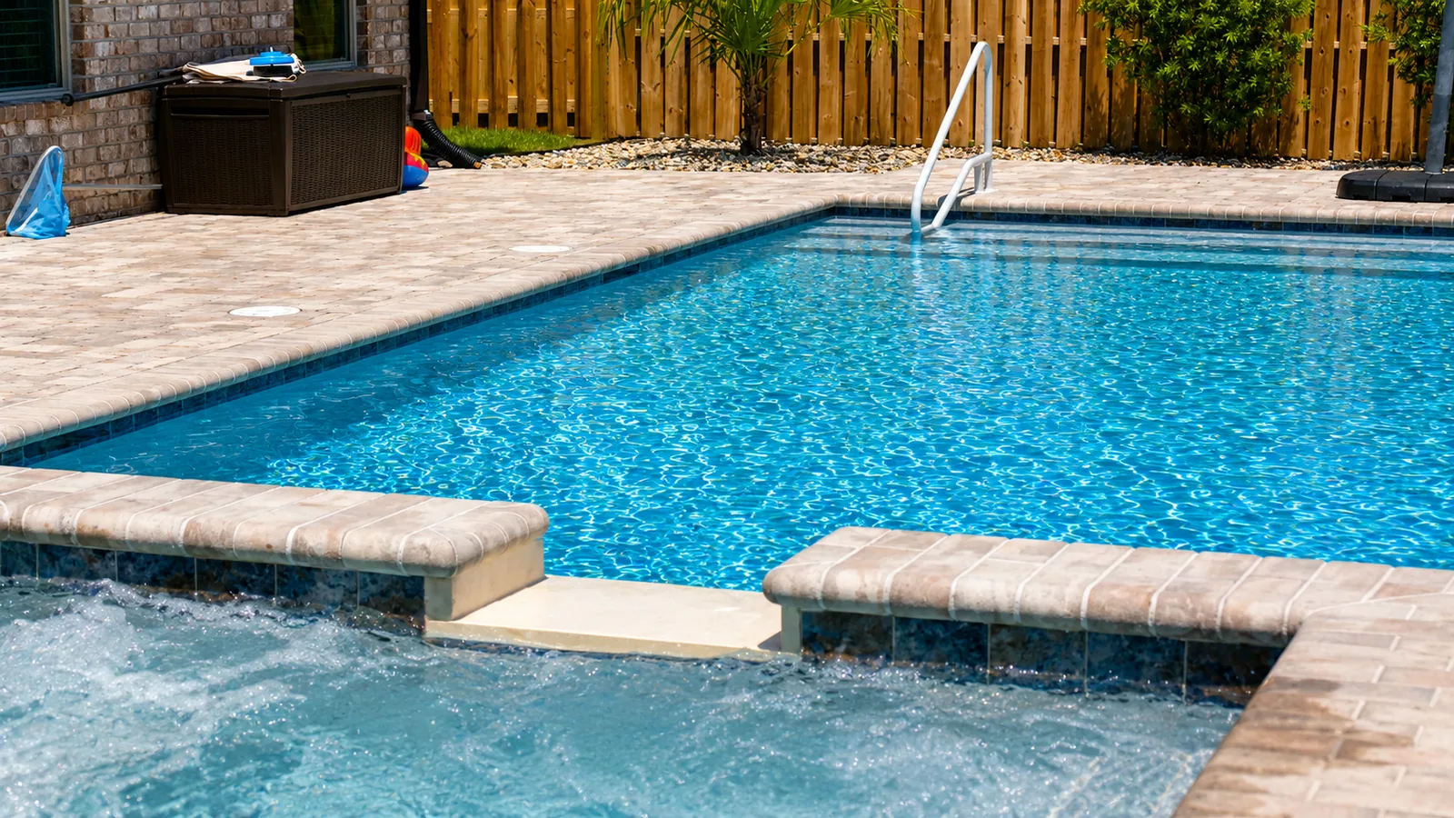 Pool coping and paver decking detail on a custom Neway pool
