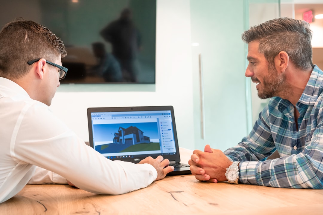 Client and pool builder reviewing 3D custom pool designs together Client and pool builder reviewing 3D custom pool designs together
