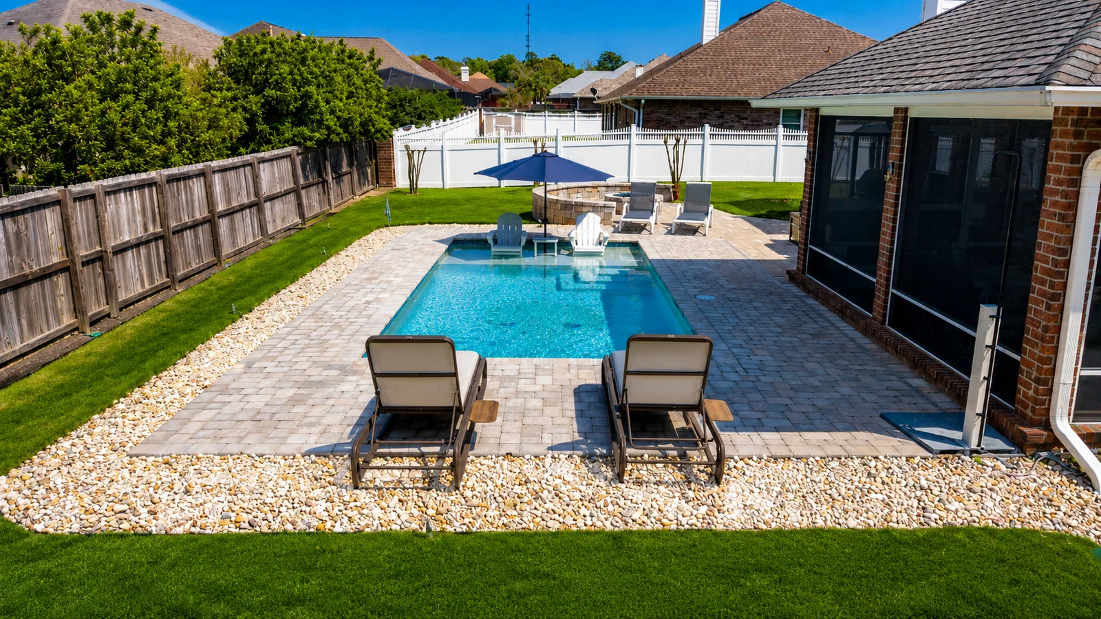 Custom rectangular swimming pool with paver decking Custom rectangular swimming pool with paver decking