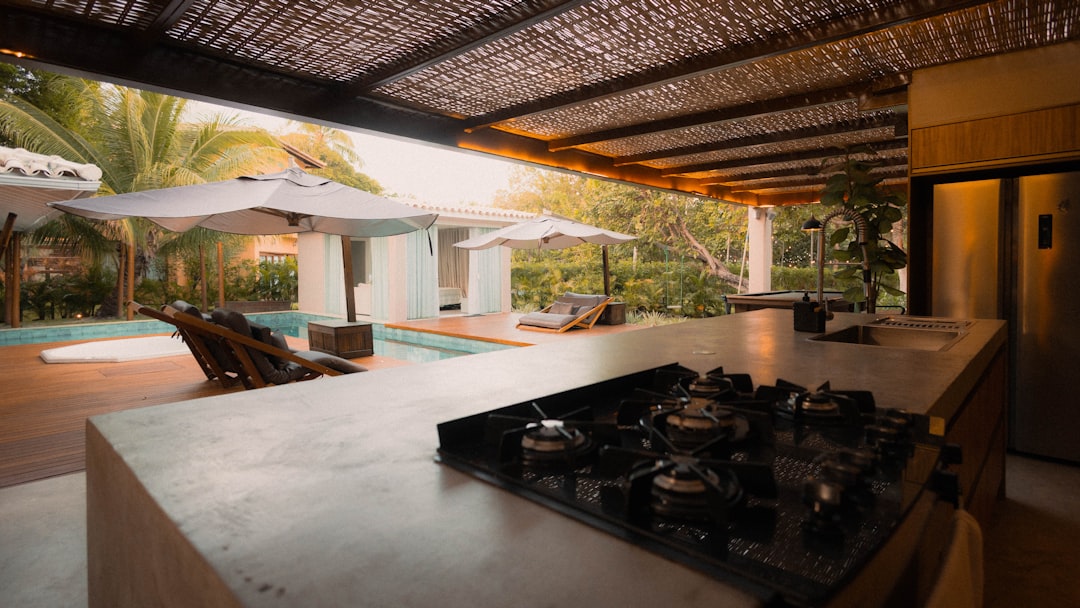 modern outdoor kitchen with built-in grill and stone countertops - Wilmington NC kitchen builders
