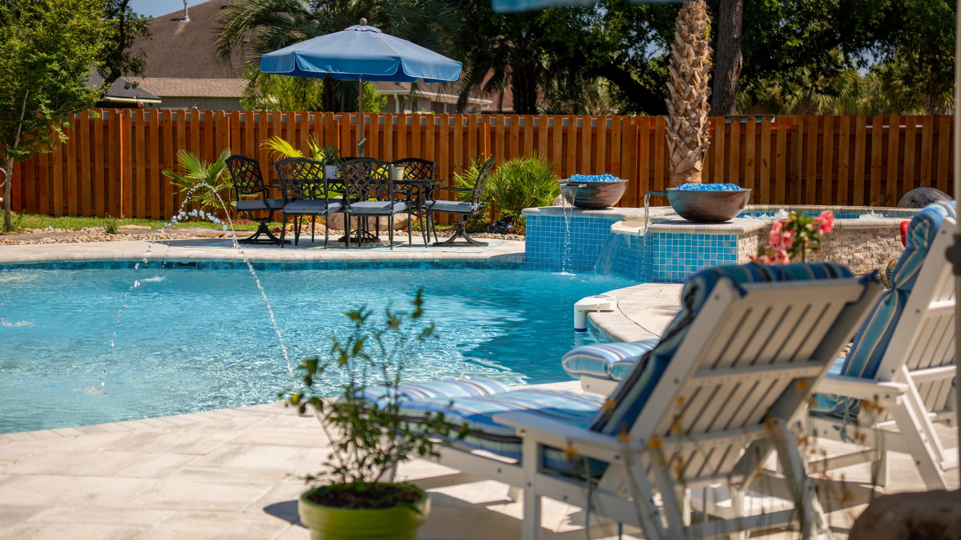 Freeform Neway pool with spa waterfall and paver patio
