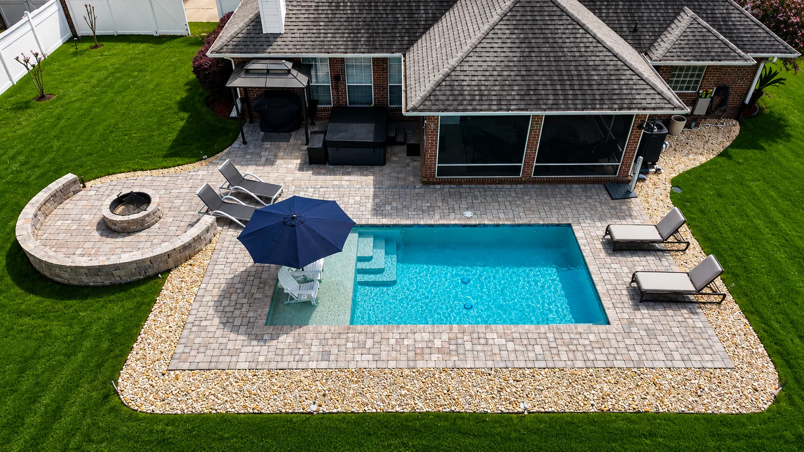 Custom Neway Pools fire feature beside a finished pool