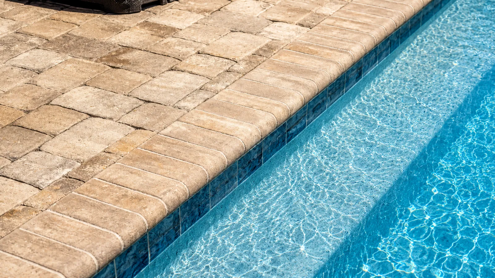 Waterline tile and coping detail on a custom Neway pool