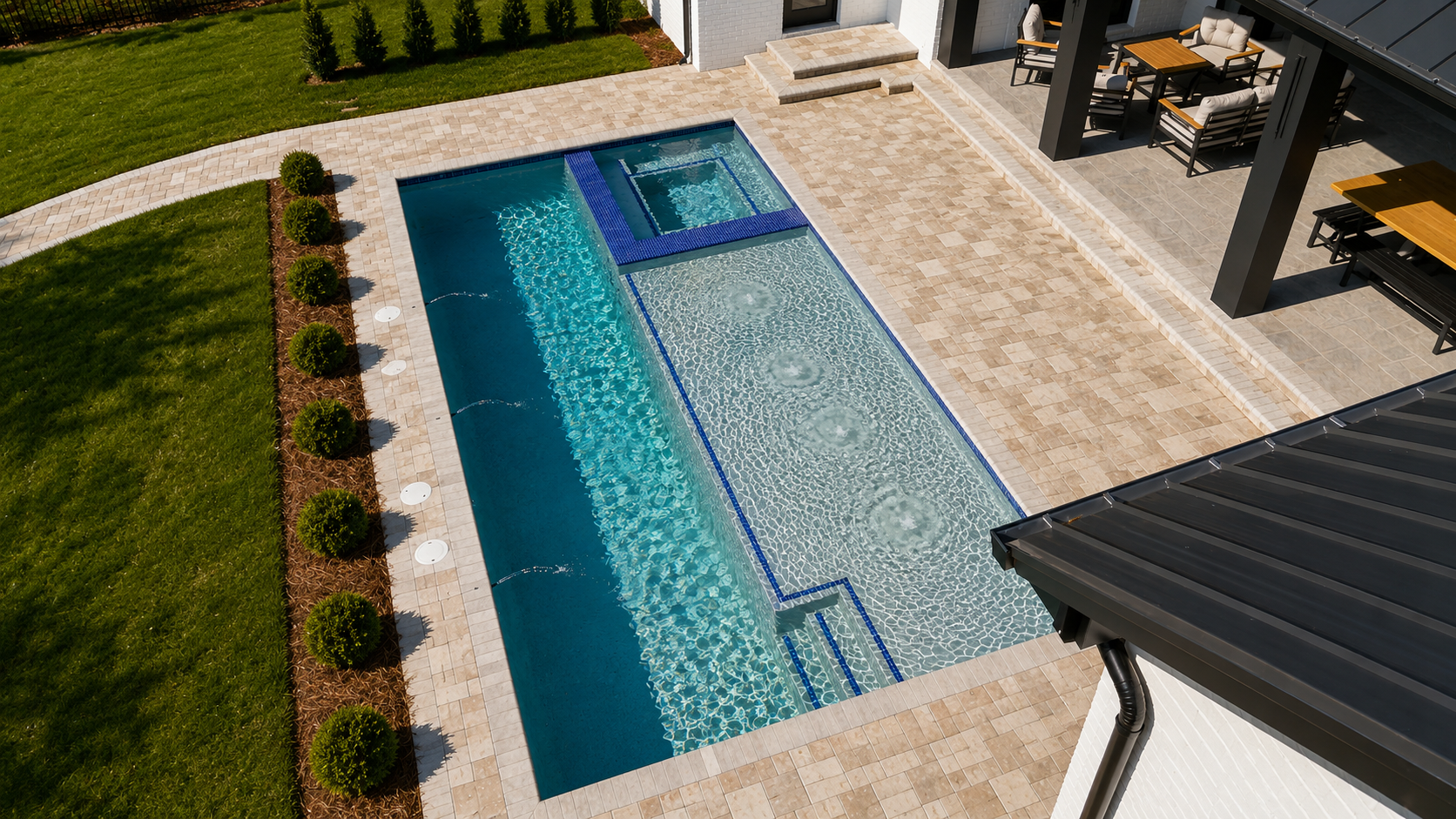 Aerial view of a modern custom pool with spa and deck jets by Neway Pools
