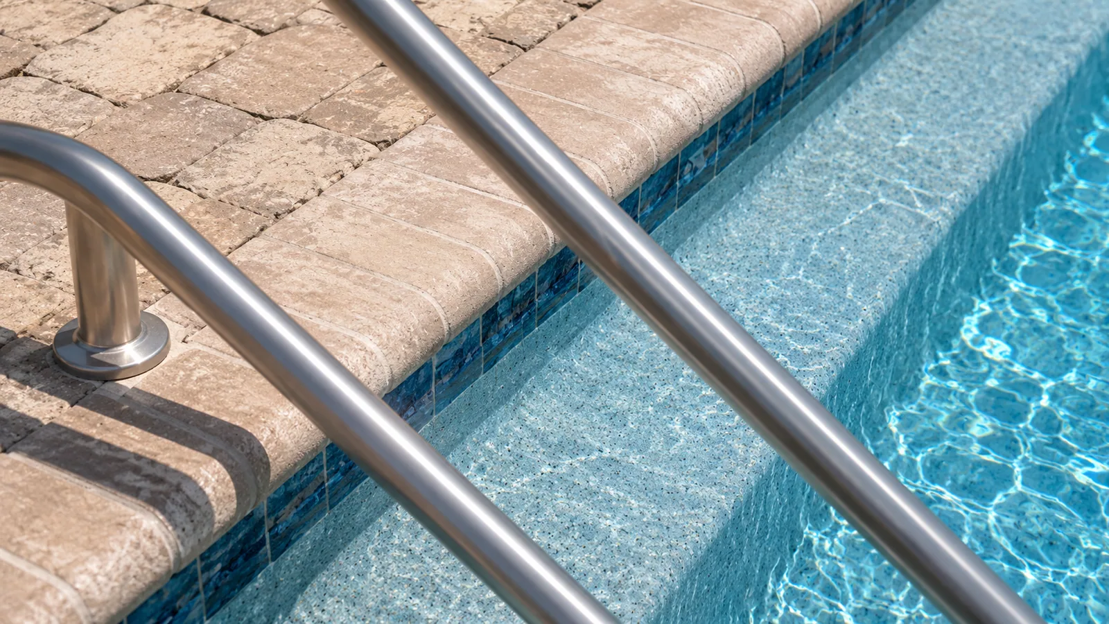 Pool coping and paver decking on a custom Neway pool