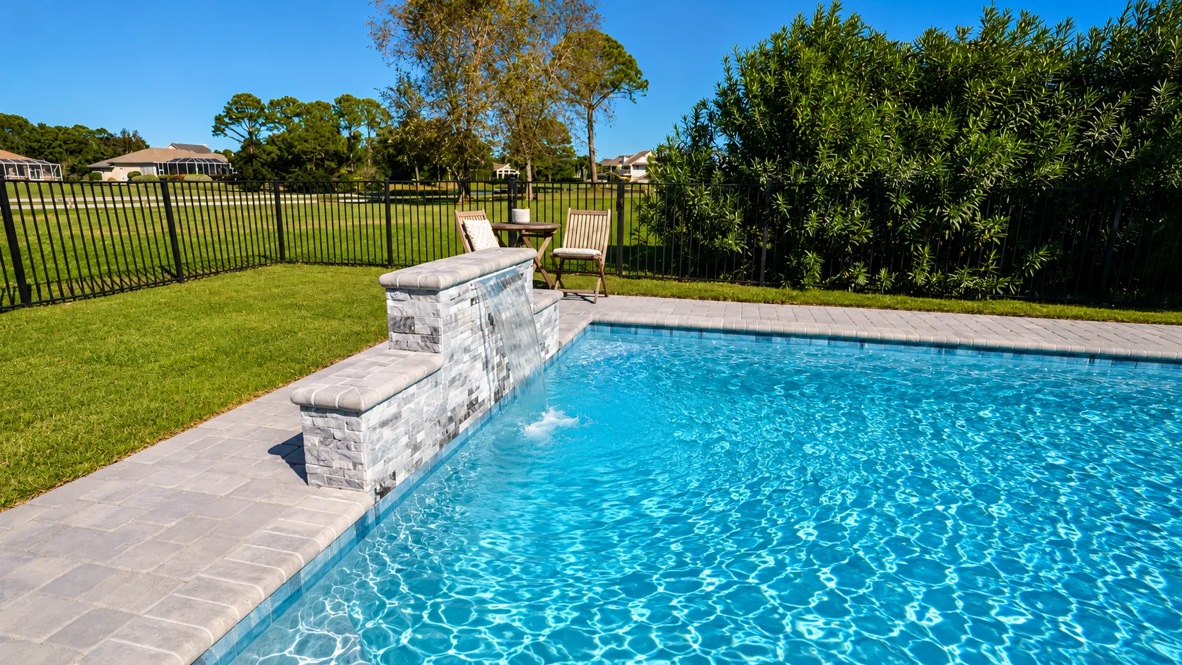 Custom pool with a tanning ledge and paver decking