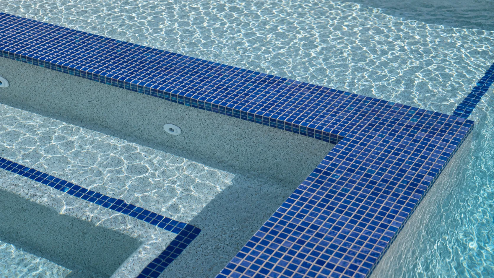 Waterline tile and coping detail on a custom Neway pool